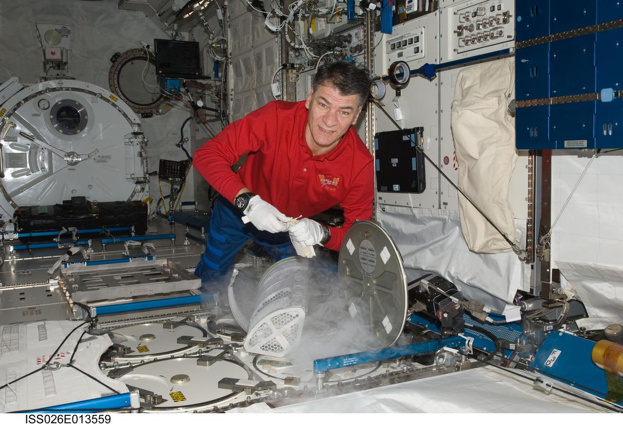 ISS026-E-013559 (26 Dec. 2010) --- European Space Agency astronaut Paolo Nespoli, Expedition 26 flight engineer, services the Minus Eighty Laboratory Freezer for ISS (MELFI-1) in the Kibo laboratory of the International Space Station.