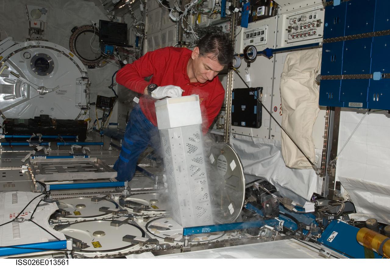 ISS026-E-013561 (26 Dec. 2010) --- European Space Agency astronaut Paolo Nespoli, Expedition 26 flight engineer, services the Minus Eighty Laboratory Freezer for ISS (MELFI-1) in the Kibo laboratory of the International Space Station.