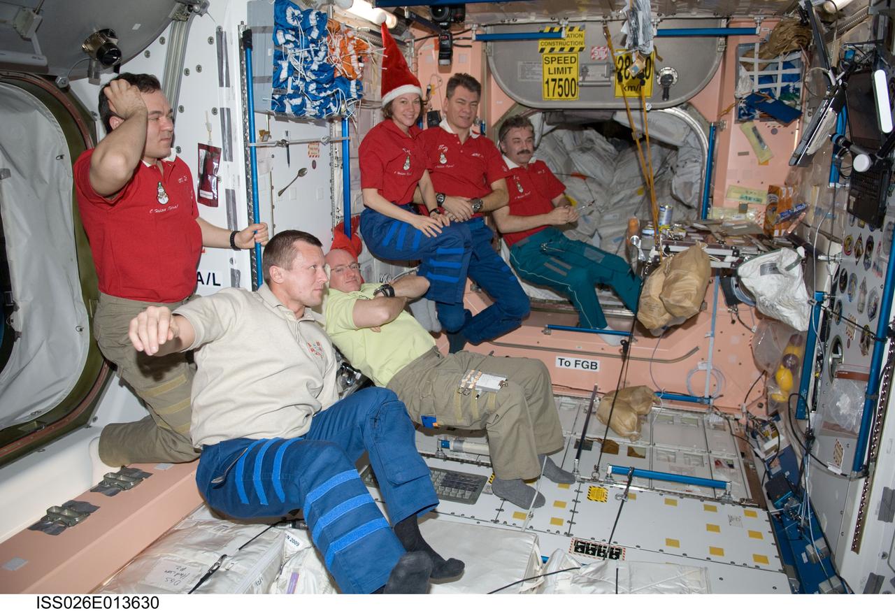 ISS026-E-013630 (31 Dec. 2010) --- Expedition 26 crew members are pictured in the Unity node of the International Space Station on New Year’s Eve. From the left are Russian cosmonauts Oleg Skripochka and Dmitry Kondratyev, both flight engineers; NASA astronaut Scott Kelly, commander; NASA astronaut Catherine (Cady) Coleman, European Space Agency astronaut Paolo Nespoli and Russian cosmonaut Alexander Kaleri, all flight engineers.