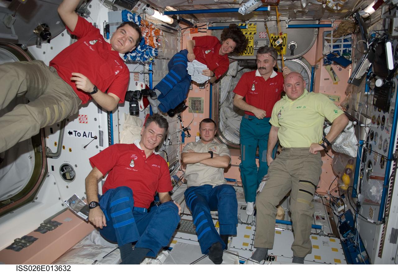 ISS026-E-013632 (31 Dec. 2010) --- Expedition 26 crew members are pictured in the Unity node of the International Space Station on New Year’s Eve. Clockwise from the left are Russian cosmonaut Oleg Skripochka, NASA astronaut Catherine (Cady) Coleman, Russian cosmonaut Alexander Kaleri, all flight engineers; NASA astronaut Scott Kelly, commander; Russian cosmonaut Dmitry Kondratyev and European Space Agency astronaut Paolo Nespoli, both flight engineers.