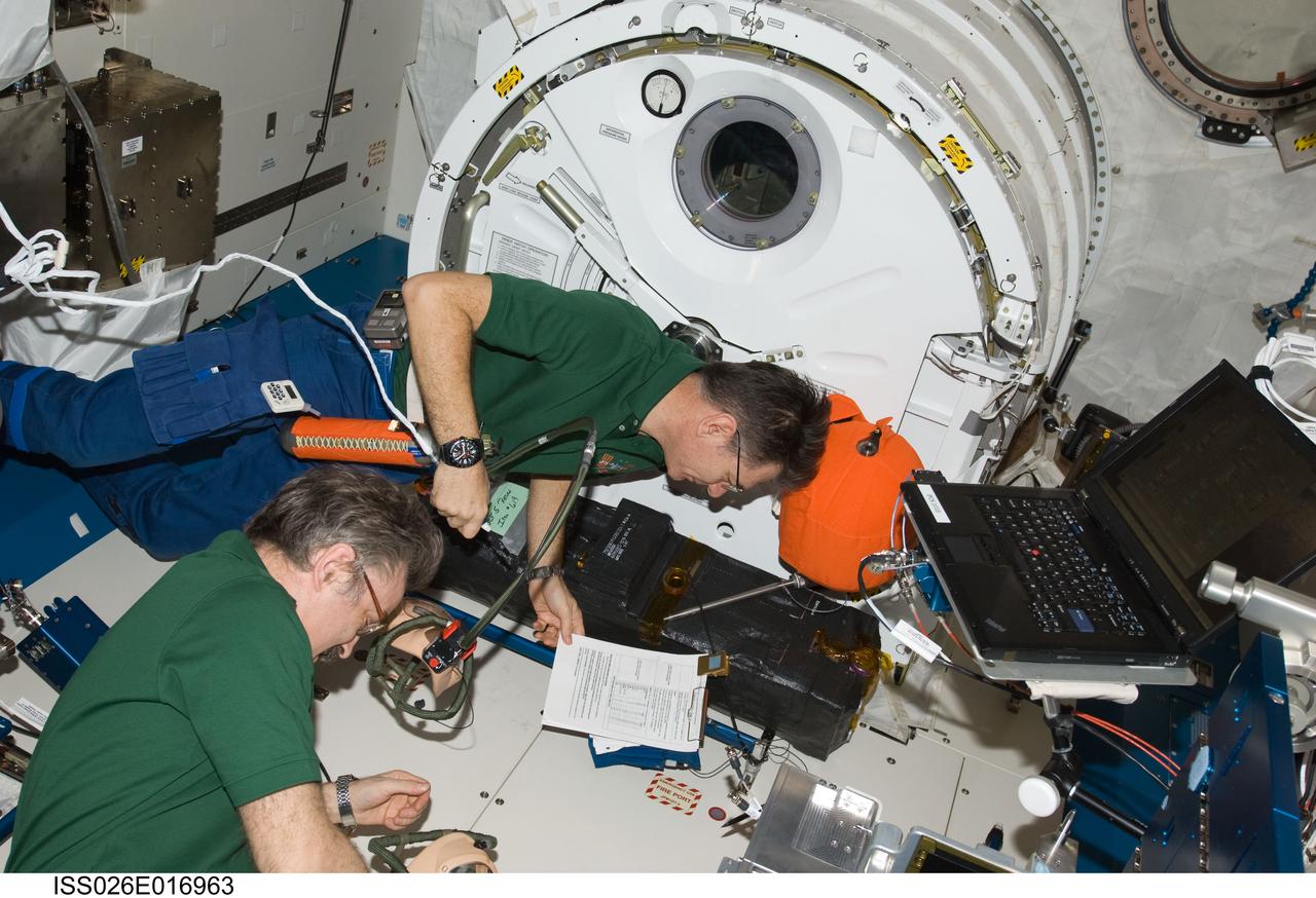 ISS026-E-016963 (11 Jan. 2011) --- Russian cosmonaut Alexander Kaleri (foreground) and European Space Agency astronaut Paolo Nespoli, both Expedition 26 flight engineers, participate in an emergency scenarios drill in the Kibo laboratory of the International Space Station.