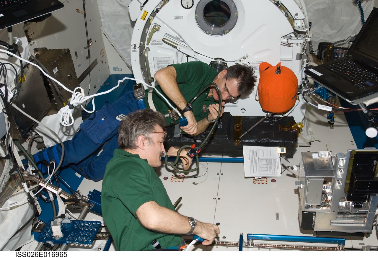 ISS026-E-016965 (11 Jan. 2011) --- Russian cosmonaut Alexander Kaleri (foreground) and European Space Agency astronaut Paolo Nespoli, both Expedition 26 flight engineers, participate in an emergency scenarios drill in the Kibo laboratory of the International Space Station.