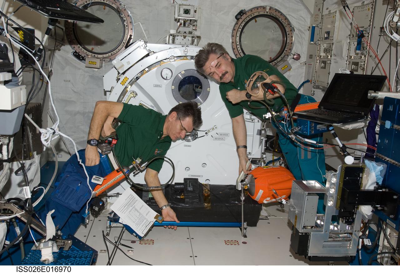 ISS026-E-016970 (11 Jan. 2011) --- Russian cosmonaut Alexander Kaleri (right) and European Space Agency astronaut Paolo Nespoli, both Expedition 26 flight engineers, participate in an emergency scenarios drill in the Kibo laboratory of the International Space Station.