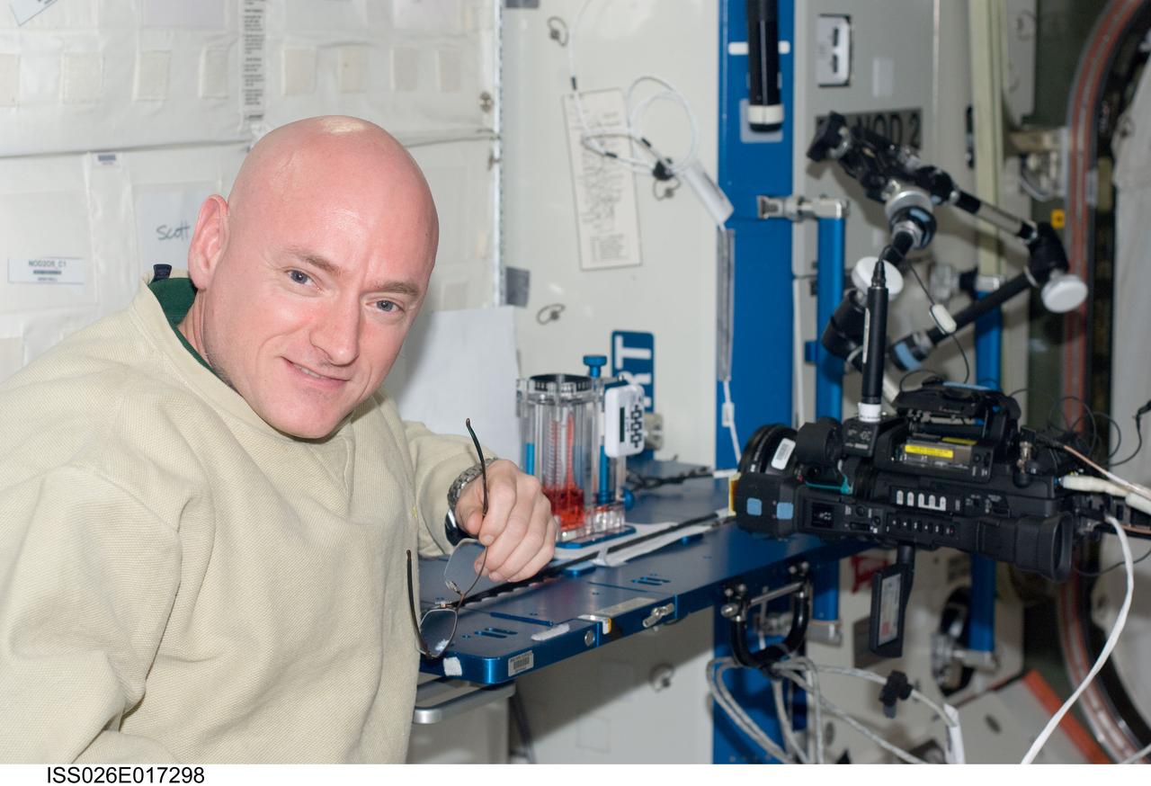ISS026-E-017298 (11 Jan. 2011) --- NASA astronaut Scott Kelly, Expedition 26 commander, is pictured near a Capillary Flow Experiment (CFE) Vane Gap-1 experiment. The CFE is positioned on the Maintenance Work Area in the Destiny laboratory of the International Space Station. CFE observes the flow of fluid, in particular capillary phenomena, in microgravity.