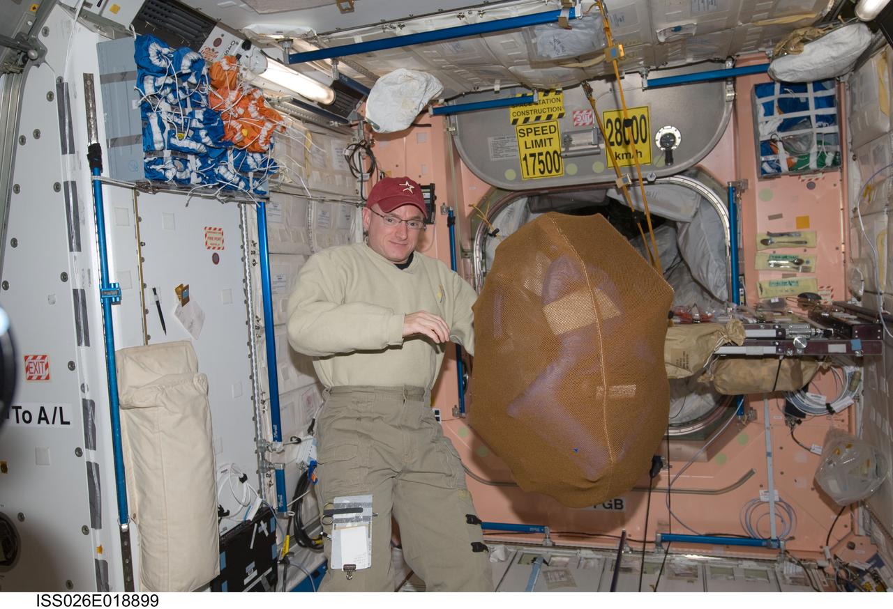 ISS026-E-018899 (21 Jan. 2011) --- NASA astronaut Scott Kelly, Expedition 26 commander, is pictured near a stowage bag floating freely in the Unity node of the International Space Station.
