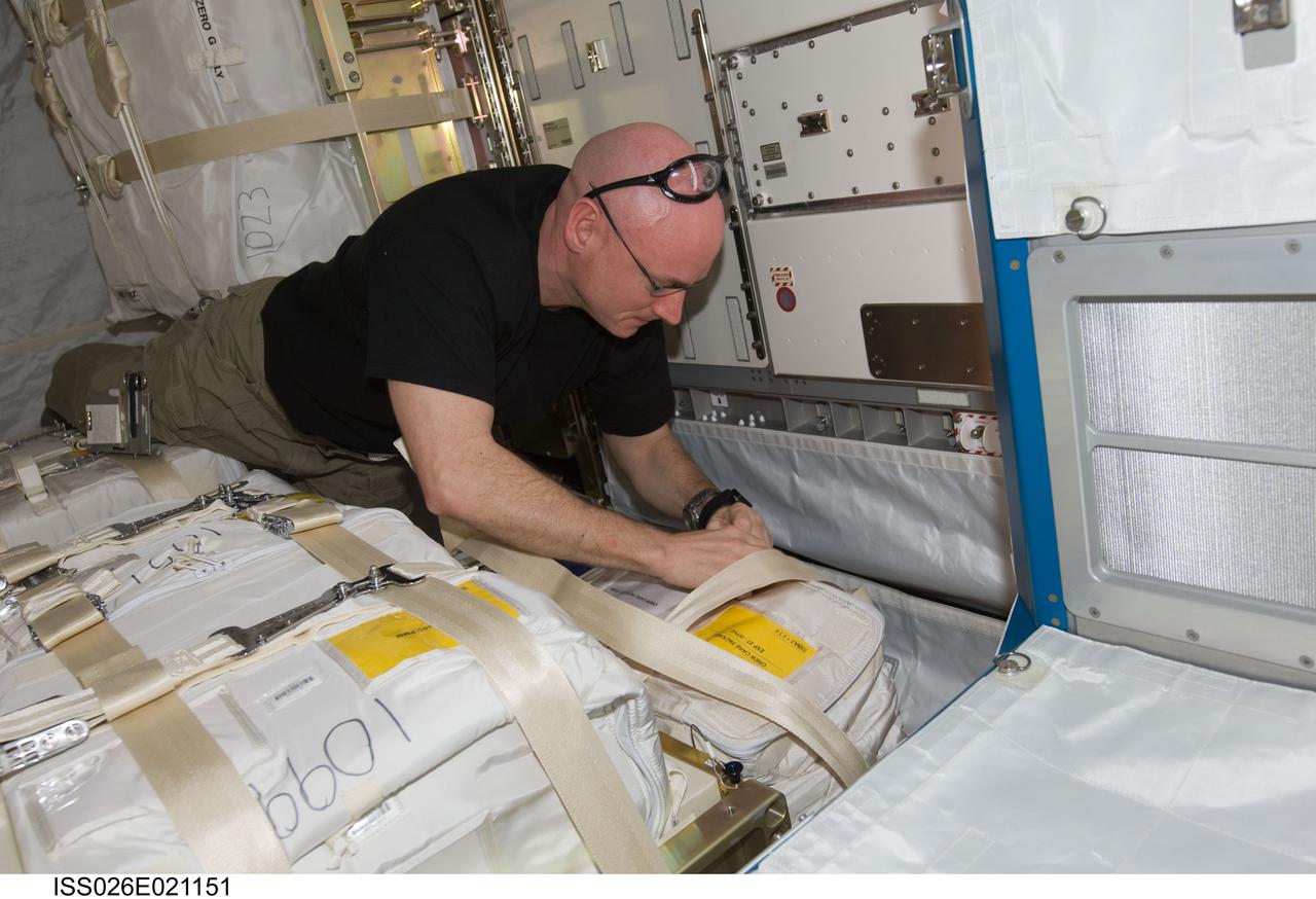 ISS026-E-021151 (27 Jan. 2011) --- NASA astronaut Scott Kelly, Expedition 26 commander, works with stowage containers in the Japanese Kounotori2 H-II Transfer Vehicle (HTV2) docked to the Harmony node of the International Space Station.