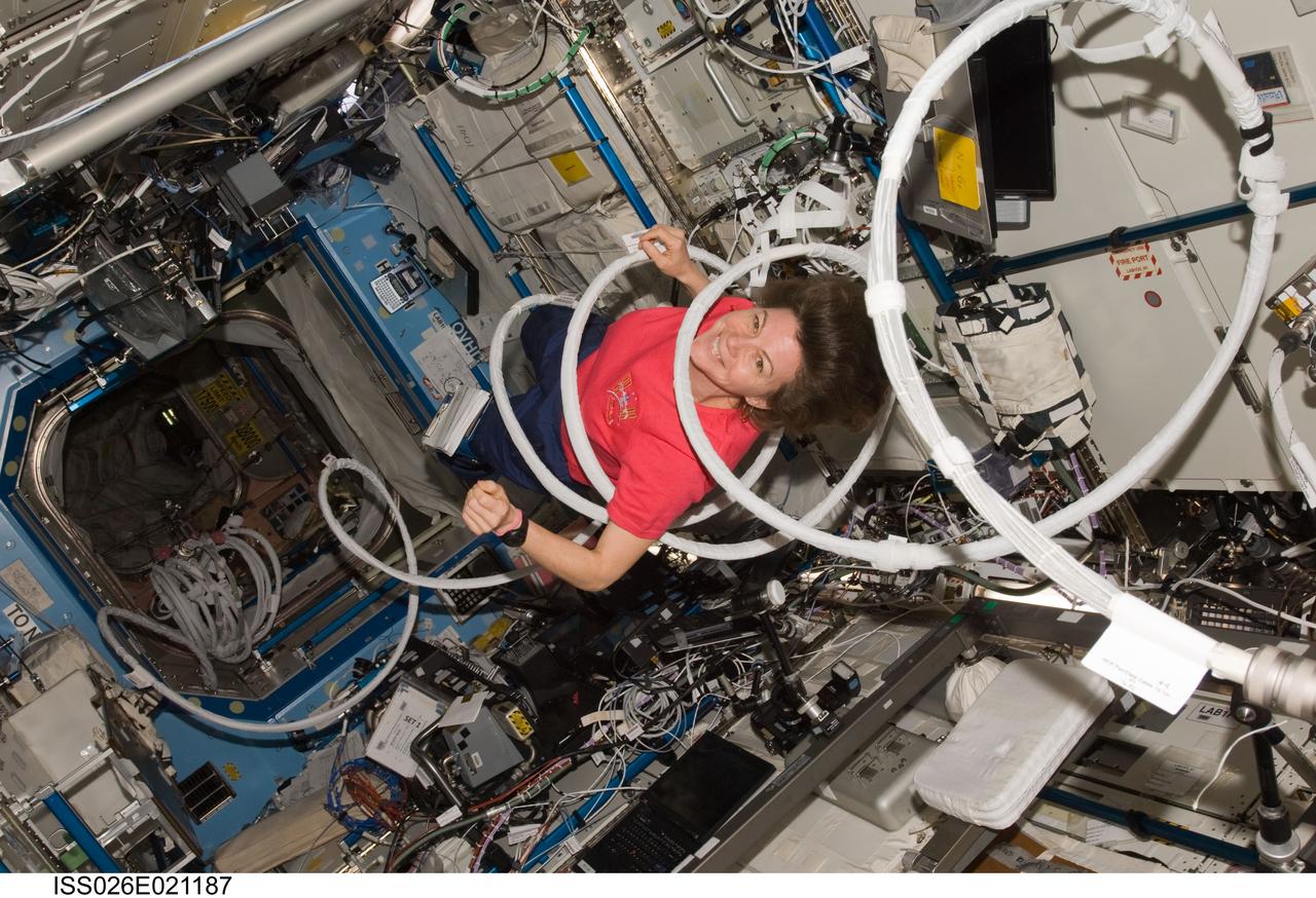 ISS026-E-021187 (27 Jan. 2011) --- NASA astronaut Catherine (Cady) Coleman, Expedition 26 flight engineer, is pictured inside a coil of cable in the Destiny laboratory of the International Space Station.