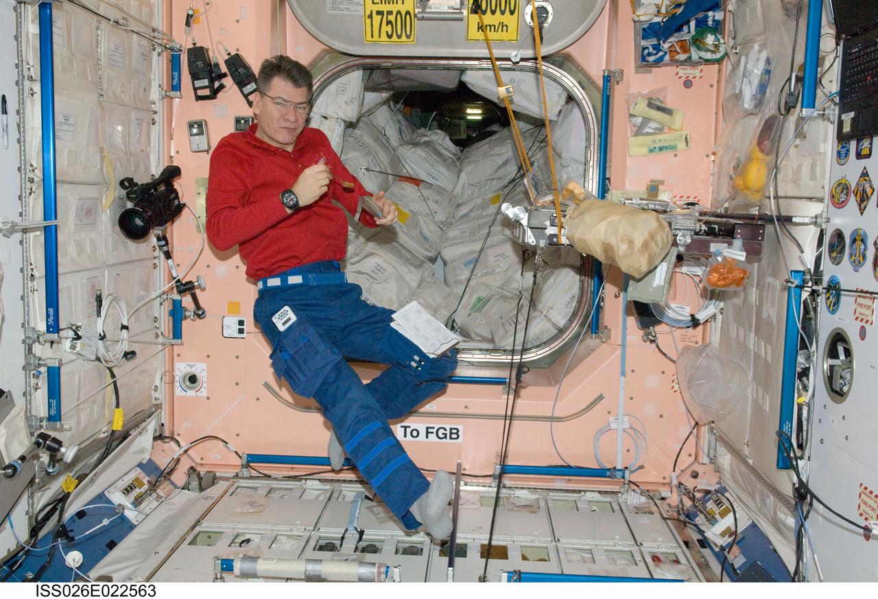 ISS026-E-022563 (27 Dec. 2010) --- European Space Agency astronaut Paolo Nespoli, Expedition 26 flight engineer, eats a snack in the Unity node of the International Space Station.