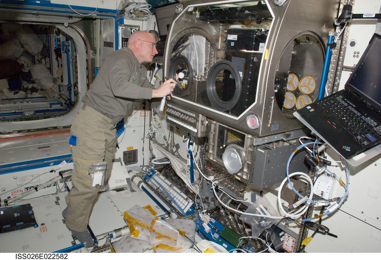 ISS026-E-022582 (27 Dec. 2010) --- NASA astronaut Scott Kelly, Expedition 26 commander, works with Capillary Channel Flow (CCF) experiment hardware in the Microgravity Science Glovebox (MSG) in the Destiny laboratory of the International Space Station. CCF is a versatile experiment for studying a critical variety of inertial-capillary dominated flows key to spacecraft systems that cannot be studied on the ground.