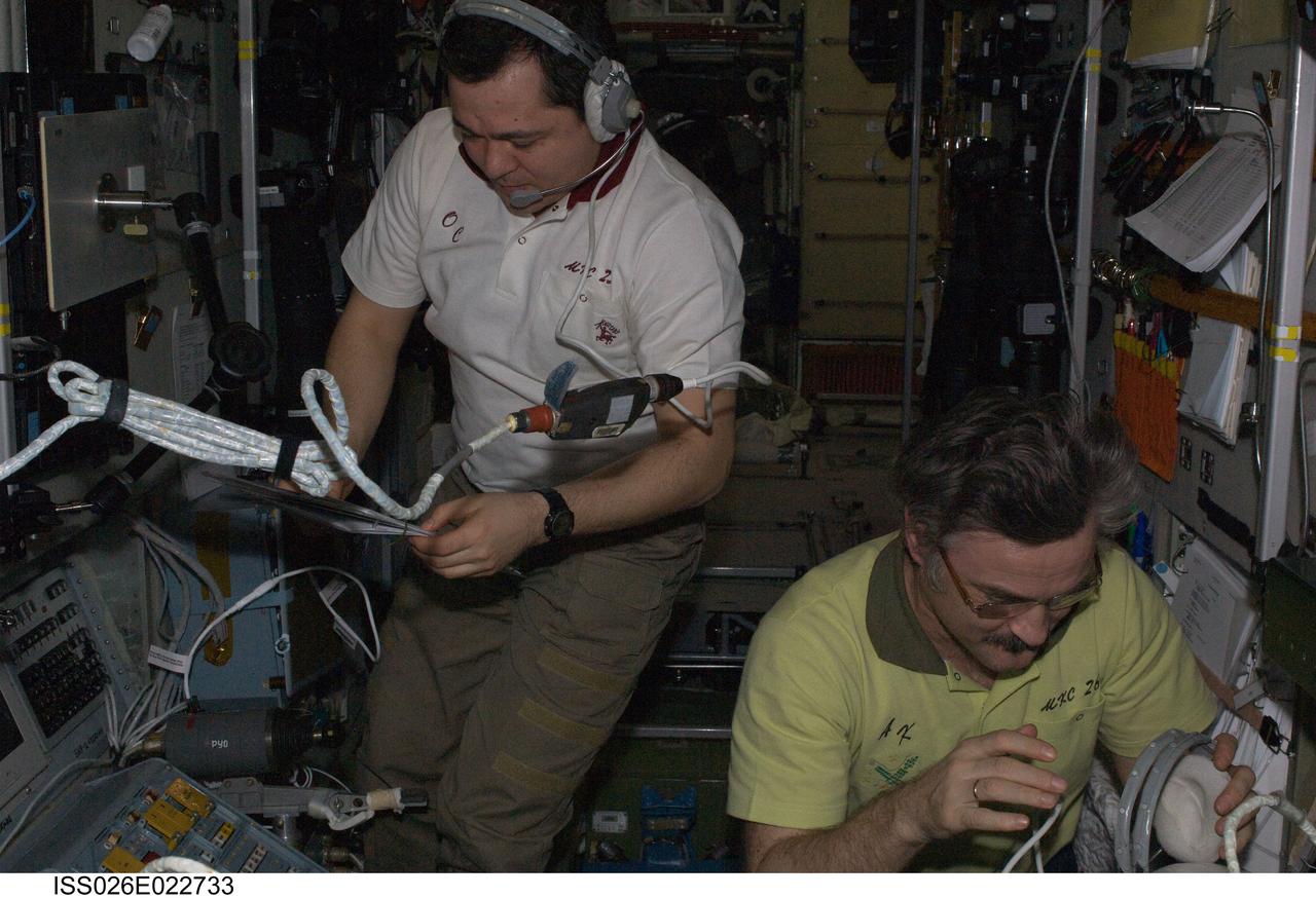ISS026-E-022733 (29 Jan. 2011) --- Russian cosmonauts Alexander Kaleri (right) and Oleg Skripochka, both Expedition 26 flight engineers, monitor data at the manual TORU docking system controls in the Zvezda Service Module of the International Space Station during the docking operations of the unpiloted ISS Progress 41 resupply vehicle. Progress 41 used the automated Kurs system to dock to the Pirs Docking Compartment at 9:39 p.m. (EST) on Jan. 29, 2011.