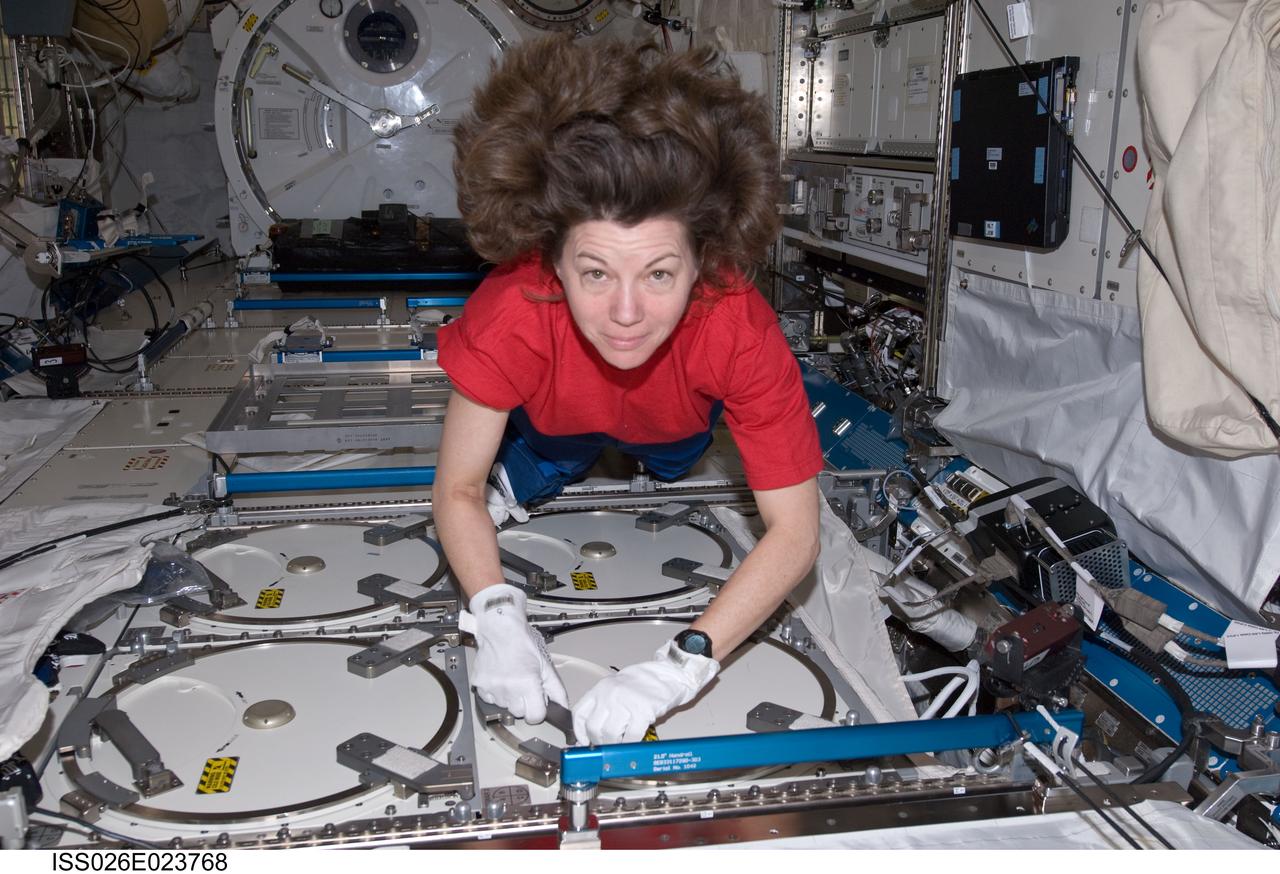 ISS026-E-023768 (27 Dec. 2010) --- NASA astronaut Catherine (Cady) Coleman, Expedition 26 flight engineer, prepares to insert samples into the Minus Eighty Degree Laboratory Freezer for ISS (MELFI) as part of the Nutritional Status Assessment (NUTRITION) study in the Japanese Kibo laboratory of the International Space Station.