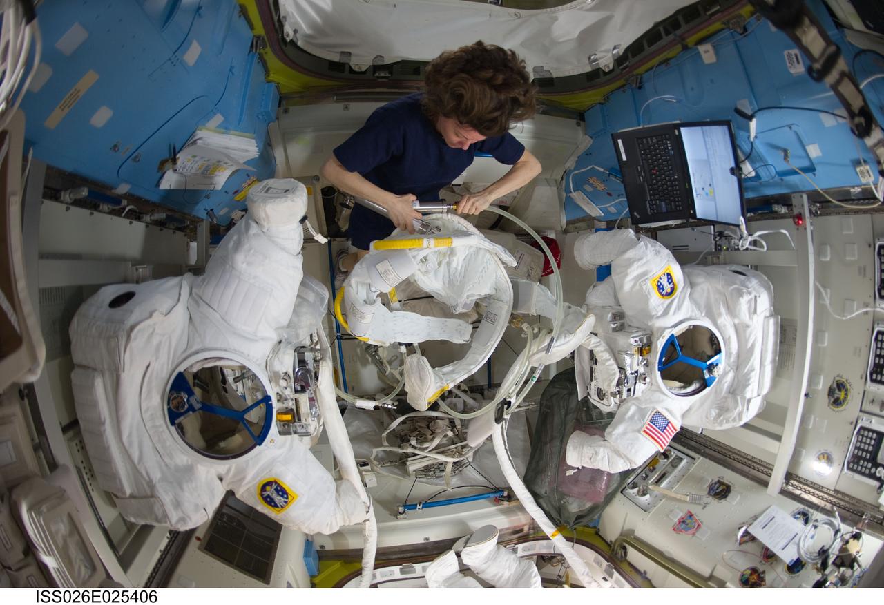 ISS026-E-025406 (9 Feb. 2011) --- NASA astronaut Catherine (Cady) Coleman, Expedition 26 flight engineer, works with Extravehicular Mobility Unit (EMU) spacesuit equipment in the Quest airlock of the International Space Station.