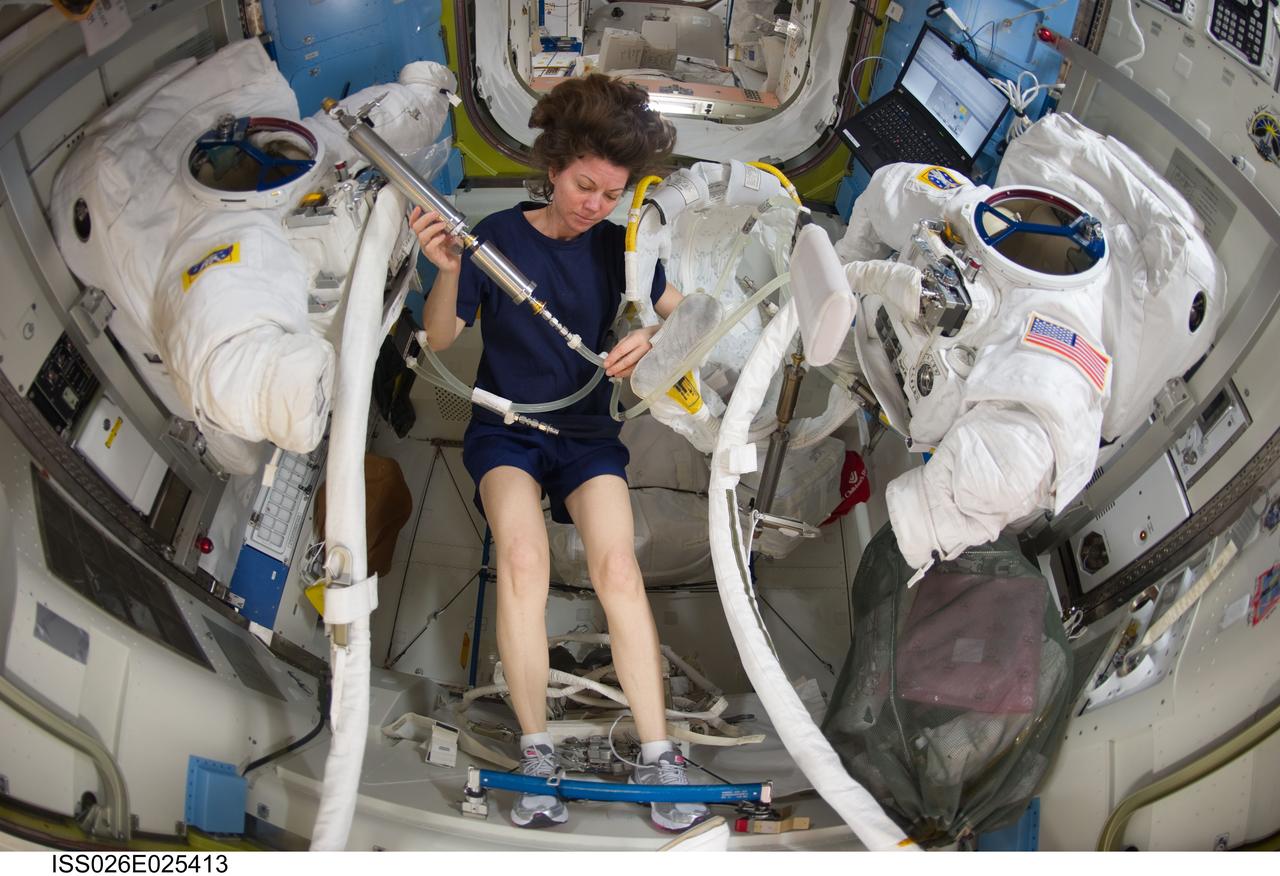 ISS026-E-025413 (9 Feb. 2011) --- NASA astronaut Catherine (Cady) Coleman, Expedition 26 flight engineer, works with Extravehicular Mobility Unit (EMU) spacesuit equipment in the Quest airlock of the International Space Station.
