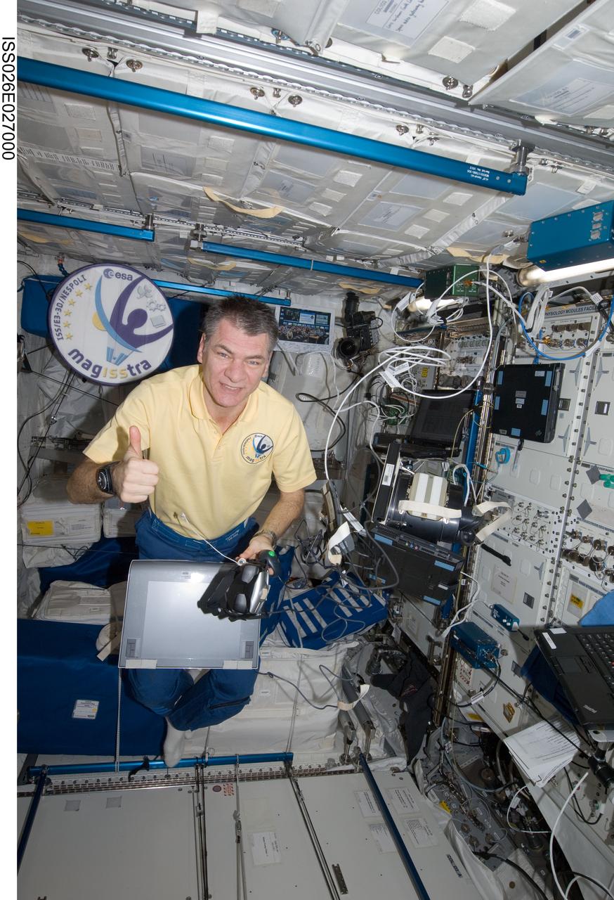 ISS026-E-027000 (12 Feb. 2011) --- European Space Agency (ESA) astronaut Paolo Nespoli, Expedition 26 flight engineer, conducts a test run with the French/CNES neuroscientific research experiment ?3D-Space? (SAP) in the Columbus laboratory of the International Space Station. While floating freely, Nespoli used the ESA multipurpose laptop with a prepared hard disk drive, data storage on a memory card, and an electronic pen table connected to it. 3D-Space, which involves distance, writing and illusion exercises, is designed to test the hypothesis that altered visual perception affects motor control.