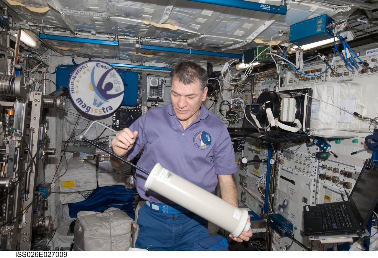 ISS026-E-027009 (14 Feb. 2011) --- European Space Agency (ESA) astronaut Paolo Nespoli, Expedition 26 flight engineer, performs periodic maintenance on the Pulmonary Function in Flight (PuFF) experiment by re-greasing the PuFF calibration syringe in the Columbus laboratory of the International Space Station.