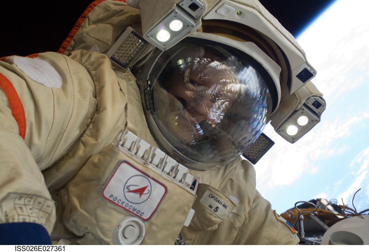 ISS026-E-027361 (16 Feb. 2011) --- Russian cosmonaut Dmitry Kondratyev, Expedition 26 flight engineer, wearing a Russian Orlan-MK spacesuit, participates in a session of extravehicular activity (EVA) focused on the installation of two scientific experiments outside the Zvezda Service Module of the International Space Station. During the four-hour, 51-minute spacewalk, Kondratyev and Russian cosmonaut Oleg Skripochka (out of frame), flight engineer, installed a pair of earthquake and lightning sensing experiments and retrieved a pair of spacecraft material evaluation panels.