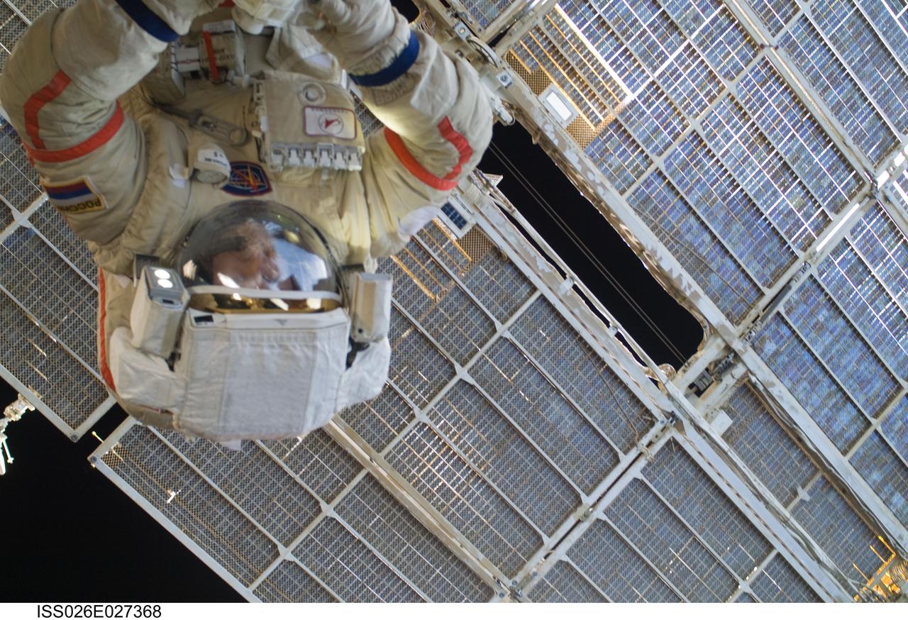 ISS026-E-027368 (16 Feb. 2011) --- Russian cosmonaut Dmitry Kondratyev, Expedition 26 flight engineer, wearing a Russian Orlan-MK spacesuit, participates in a session of extravehicular activity (EVA) focused on the installation of two scientific experiments outside the Zvezda Service Module of the International Space Station. During the four-hour, 51-minute spacewalk, Kondratyev and Russian cosmonaut Oleg Skripochka (out of frame), flight engineer, installed a pair of earthquake and lightning sensing experiments and retrieved a pair of spacecraft material evaluation panels.