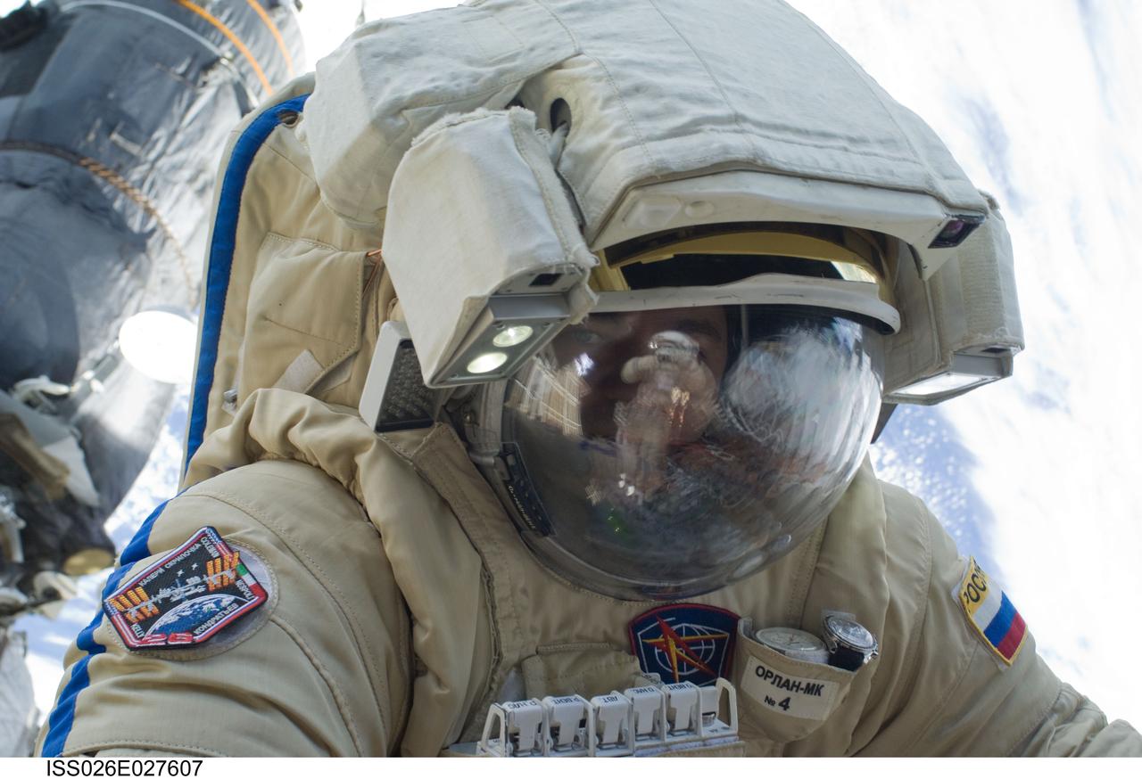 ISS026-E-027607 (16 Feb. 2011) --- Russian cosmonaut Oleg Skripochka, Expedition 26 flight engineer, wearing a Russian Orlan-MK spacesuit, participates in a session of extravehicular activity (EVA) focused on the installation of two scientific experiments outside the Zvezda Service Module of the International Space Station. During the four-hour, 51-minute spacewalk, Skripochka and Russian cosmonaut Dmitry Kondratyev (visible in the reflections in Skripochka’s helmet visor), flight engineer, installed a pair of earthquake and lightning sensing experiments and retrieved a pair of spacecraft material evaluation panels.