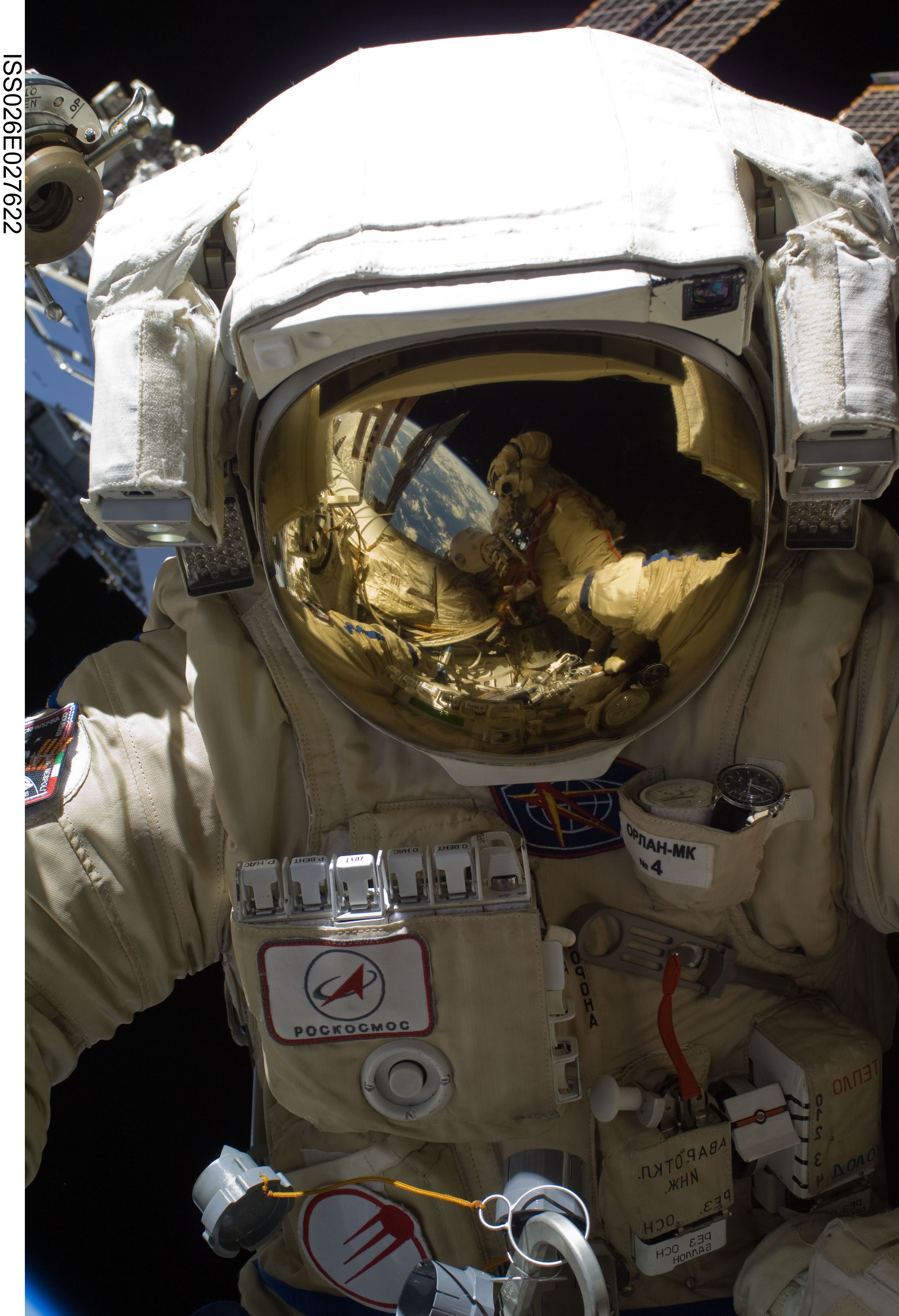 ISS026-E-027622 (16 Feb. 2011) --- Russian cosmonaut Oleg Skripochka, Expedition 26 flight engineer, wearing a Russian Orlan-MK spacesuit, participates in a session of extravehicular activity (EVA) focused on the installation of two scientific experiments outside the Zvezda Service Module of the International Space Station. During the four-hour, 51-minute spacewalk, Skripochka and Russian cosmonaut Dmitry Kondratyev (visible in the reflections in Skripochka’s helmet visor), flight engineer, installed a pair of earthquake and lightning sensing experiments and retrieved a pair of spacecraft material evaluation panels.