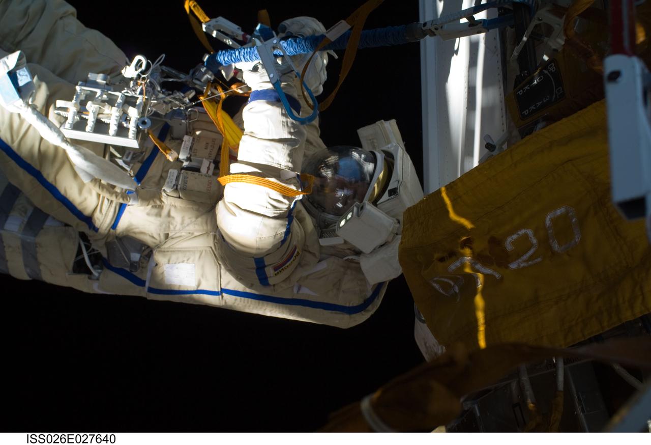 ISS026-E-027640 (16 Feb. 2011) --- Russian cosmonaut Oleg Skripochka, Expedition 26 flight engineer, wearing a Russian Orlan-MK spacesuit, participates in a session of extravehicular activity (EVA) focused on the installation of two scientific experiments outside the Zvezda Service Module of the International Space Station. During the four-hour, 51-minute spacewalk, Skripochka and Russian cosmonaut Dmitry Kondratyev (out of frame), flight engineer, installed a pair of earthquake and lightning sensing experiments and retrieved a pair of spacecraft material evaluation panels.