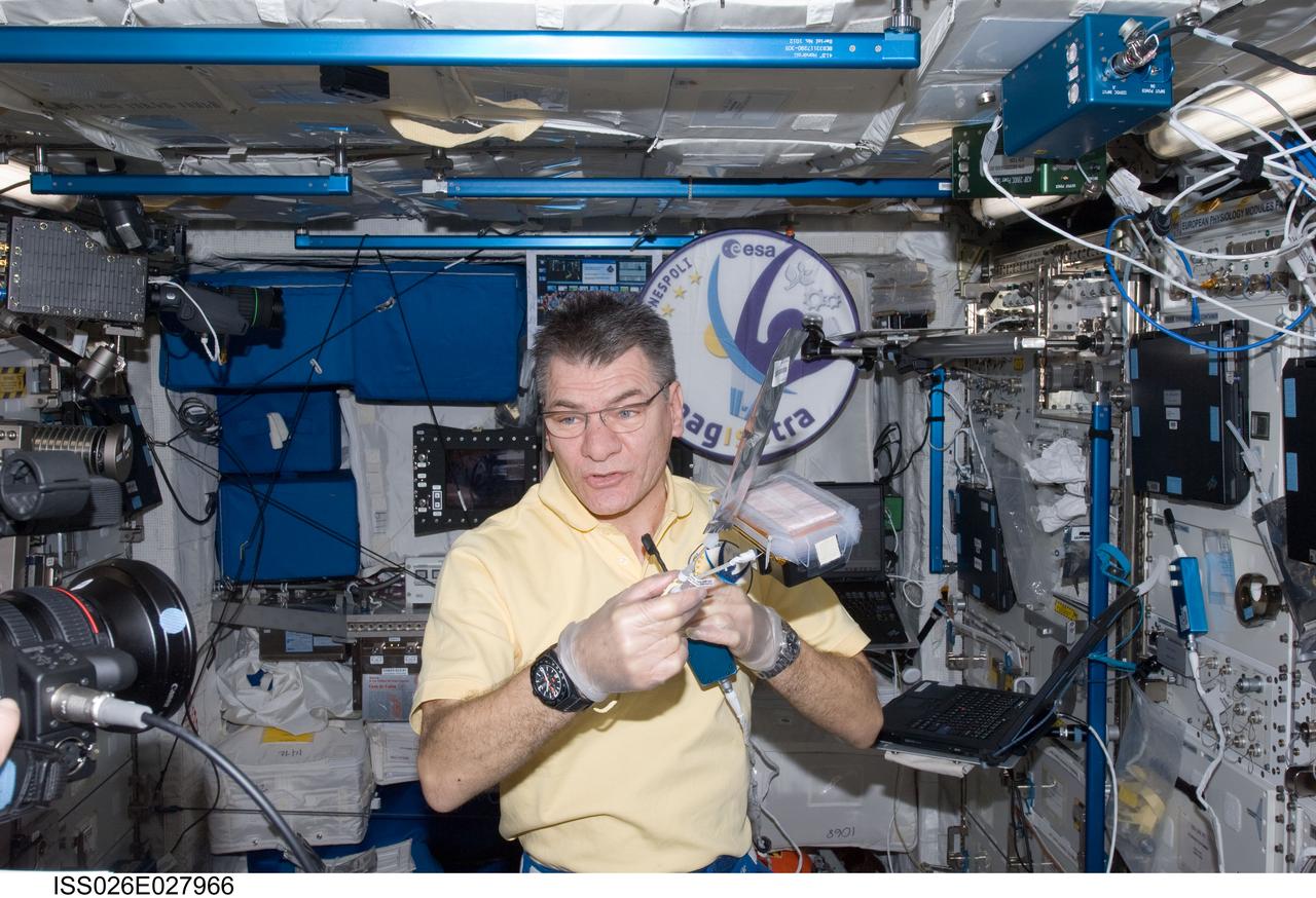 ISS026-E-027966 (17 Feb. 2011) --- European Space Agency astronaut Paolo Nespoli, Expedition 26 flight engineer, works with hardware containing Arabidopsis seeds in the Columbus laboratory of the International Space Station.