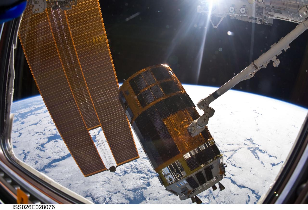 ISS026-E-028076 (18 Feb. 2011) --- In the grasp of the International Space Station?s Canadarm2, the Japanese Kounotori2 H-II Transfer Vehicle (HTV2) is relocated from the Harmony node nadir port to Harmony?s zenith port. NASA astronaut Catherine (Cady) Coleman and European Space Agency astronaut Paolo Nespoli, both Expedition 26 flight engineers, moved the HTV2, operating the station?s robotic arm from the controls inside the Cupola. A cloud-covered part of Earth and the blackness of space provide the backdrop for the scene.
