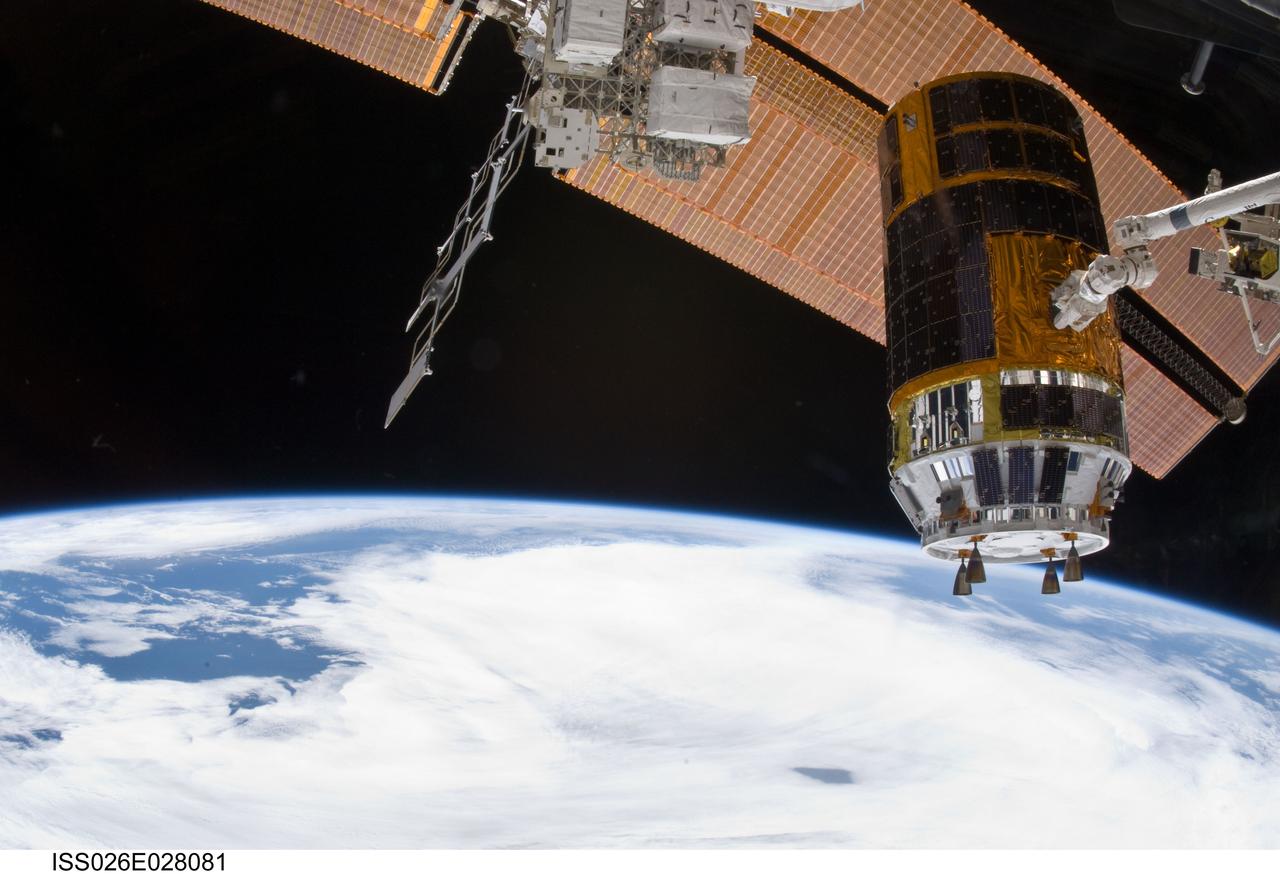 ISS026-E-028081 (18 Feb. 2011) --- In the grasp of the International Space Station?s Canadarm2, the Japanese Kounotori2 H-II Transfer Vehicle (HTV2) is relocated from the Harmony node nadir port to Harmony?s zenith port. NASA astronaut Catherine (Cady) Coleman and European Space Agency astronaut Paolo Nespoli, both Expedition 26 flight engineers, moved the HTV2, operating the station?s robotic arm from the controls inside the Cupola. A cloud-covered part of Earth and the blackness of space provide the backdrop for the scene.