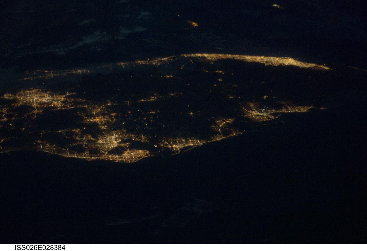 ISS026-E-028384 (22 Feb. 2011) --- This high oblique night time view of the bottom two thirds of the Florida peninsula, photographed by an Expedition 26 crew member aboard the International Space Station at 220 miles above Earth, displays many of the state's well-lighted metropolitan areas. The crew member used a digital still camera equipped with an 80-mm lens to expose the frame. The station was above the Gulf of Mexico, facing eastward toward the Atlantic, at the time the photo was taken.