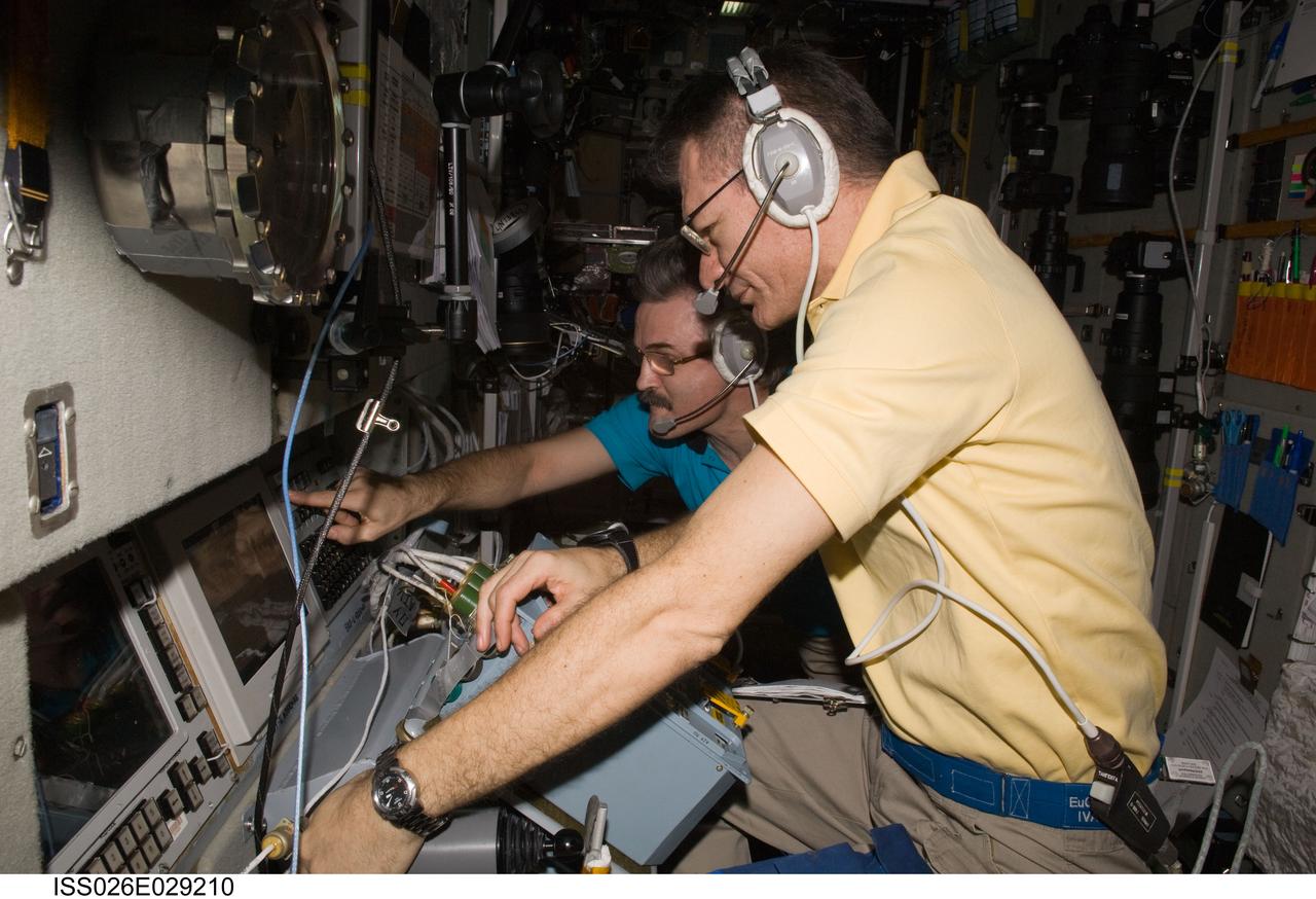 ISS026-E-029210 (24 Feb. 2011) --- European Space Agency astronaut Paolo Nespoli (foreground) and Russian cosmonaut Alexander Kaleri, both Expedition 26 flight engineers, monitor the approach and docking of the European Space Agency's "Johannes Kepler" Automated Transfer Vehicle-2 (ATV-2). The ATV2 automatically docked with the aft end of the International Space Station's Zvezda Service Module at 10:59 a.m. (EST) on Feb. 24, 2011.