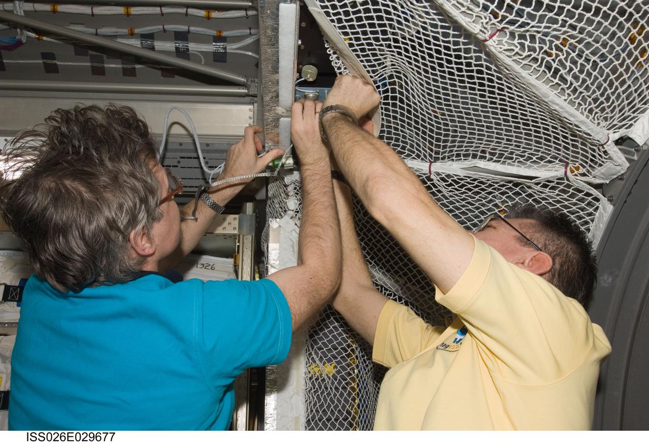 ISS026-E-029677 (25 Feb. 2011) --- European Space Agency astronaut Paolo Nespoli (right) and Russian cosmonaut Alexander Kaleri, both Expedition 26 flight engineers, work in the newly-attached European Space Agency's "Johannes Kepler" Automated Transfer Vehicle-2 (ATV-2) of the International Space Station.