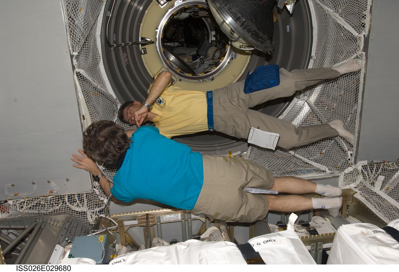 ISS026-E-029680 (25 Feb. 2011) --- European Space Agency astronaut Paolo Nespoli (top) and Russian cosmonaut Alexander Kaleri, both Expedition 26 flight engineers, work in the newly-attached European Space Agency's "Johannes Kepler" Automated Transfer Vehicle-2 (ATV-2) of the International Space Station.