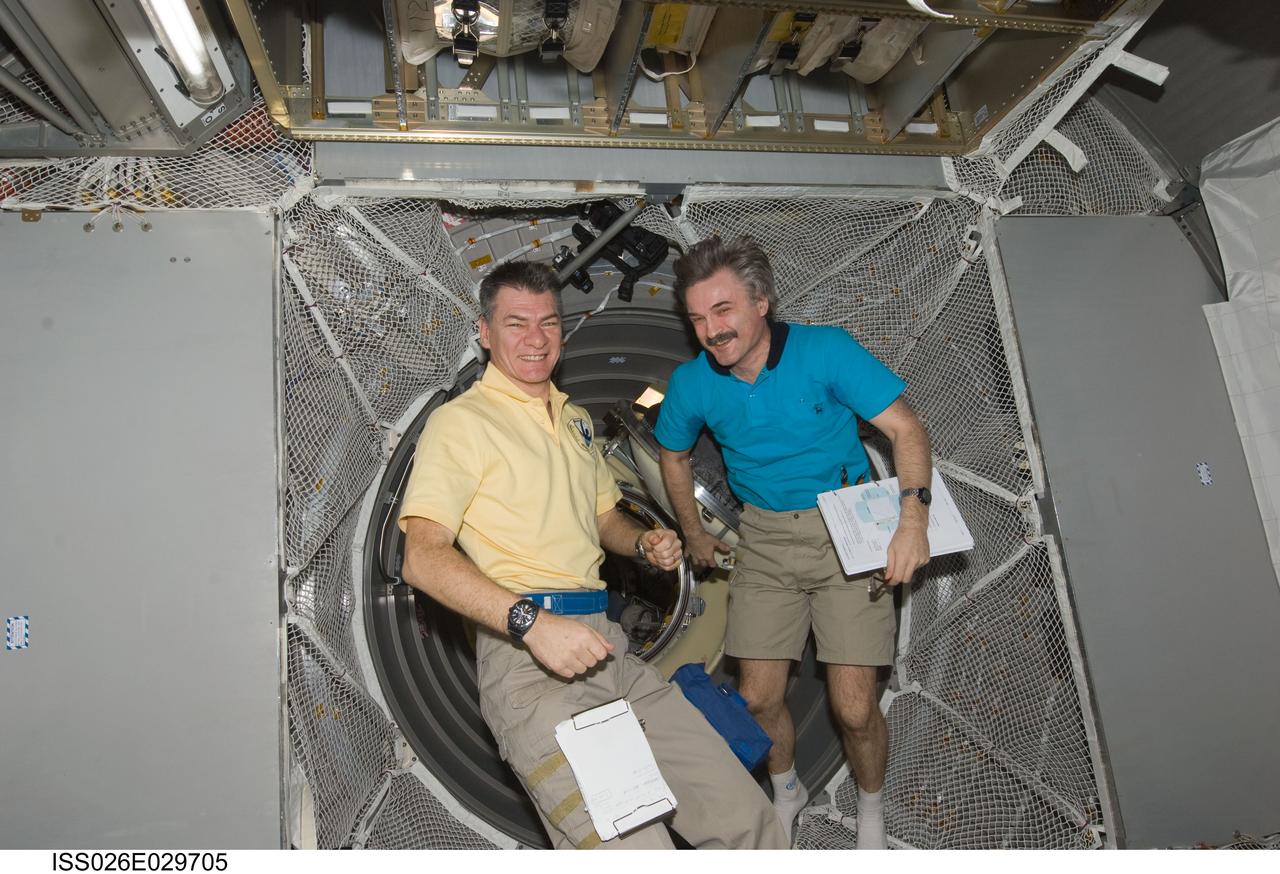ISS026-E-029705 (25 Feb. 2011) --- European Space Agency astronaut Paolo Nespoli (left) and Russian cosmonaut Alexander Kaleri, both Expedition 26 flight engineers, are pictured in the newly-attached European Space Agency's "Johannes Kepler" Automated Transfer Vehicle-2 (ATV-2) of the International Space Station.