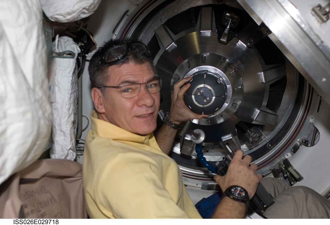 ISS026-E-029718 (25 Feb. 2011) --- As part of inverse activities onboard the International Space Station, European Space Agency astronaut Paolo Nespoli, Expedition 26 flight engineer,  removes the docking mechanism to gain access to the ATV hatch.