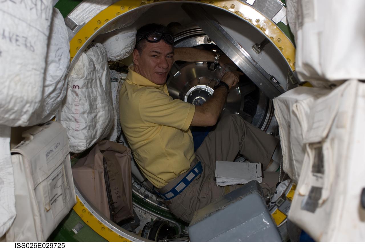 ISS026-E-029725 (25 Feb. 2011) --- As part of inverse activities onboard the International Space Station, European Space Agency astronaut Paolo Nespoli, Expedition 26 flight engineer,  removes the docking mechanism to gain access to the ATV hatch.
