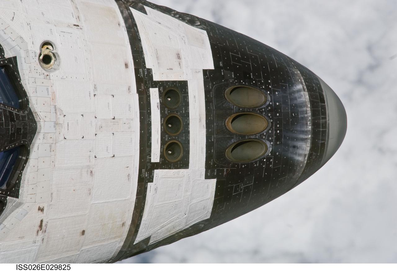 ISS026-E-029825 (26 Feb. 2011) --- This close-up view of the nose of space shuttle Discovery was provided by an Expedition 26 crew member during a survey of the approaching STS-133 vehicle prior to docking with the International Space Station. As part of the survey and part of every mission's activities, Discovery performed a back-flip for the rendezvous pitch maneuver (RPM). The station crew member used a digital still camera with an 800mm focal length, as the two spacecraft were approximately 600 feet (180 meters) apart.