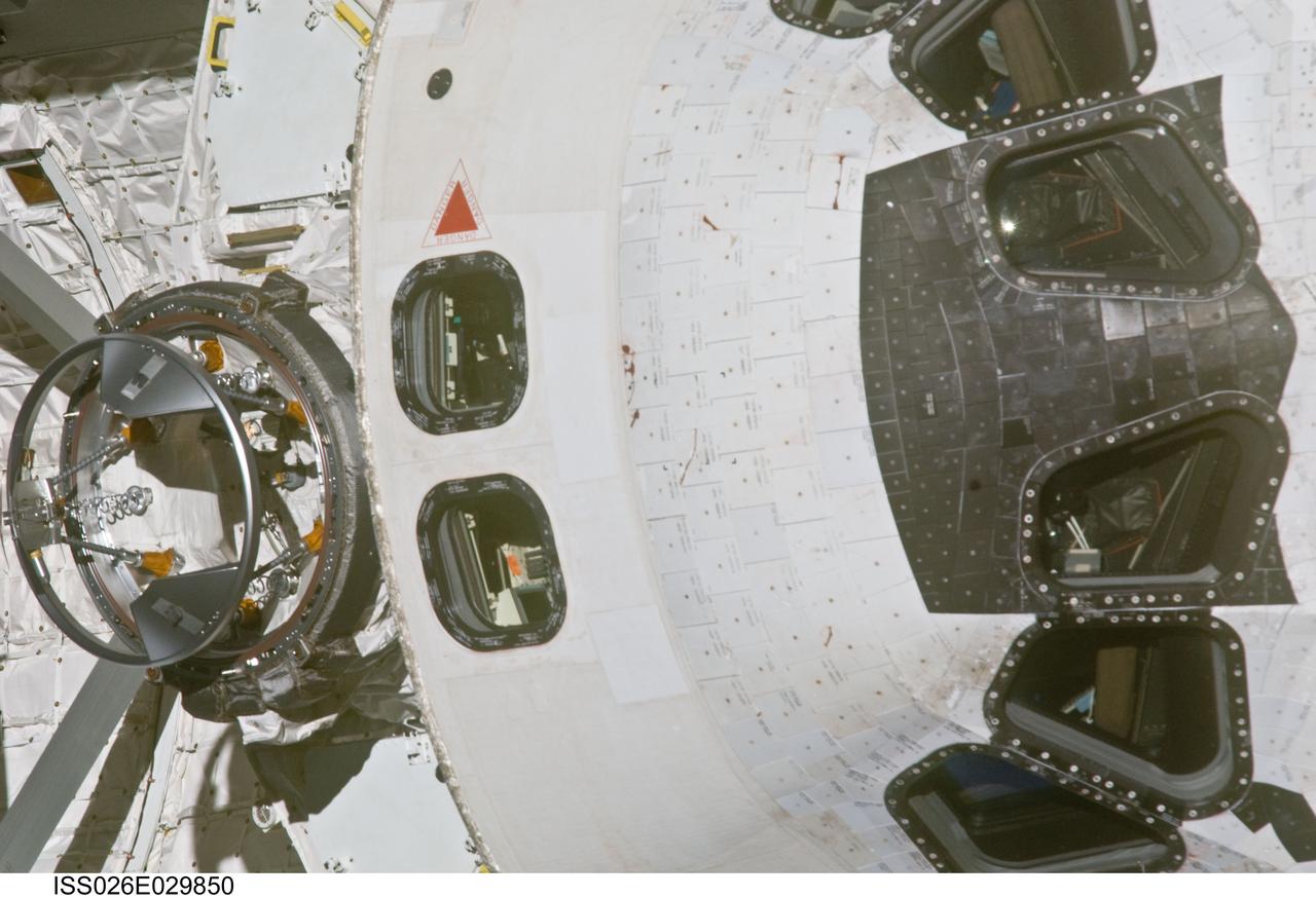 ISS026-E-029850 (26 Feb. 2011) --- This close-up view of the crew cabin and forward cargo bay of space shuttle Discovery was provided by an Expedition 26 crew member during a survey of the approaching STS-133 vehicle prior to docking with the International Space Station. As part of the survey and part of every mission's activities, Discovery performed a back-flip for the rendezvous pitch maneuver (RPM). The station crew member used a digital still camera with an 800mm focal length, as the two spacecraft were approximately 600 feet (180 meters) apart.