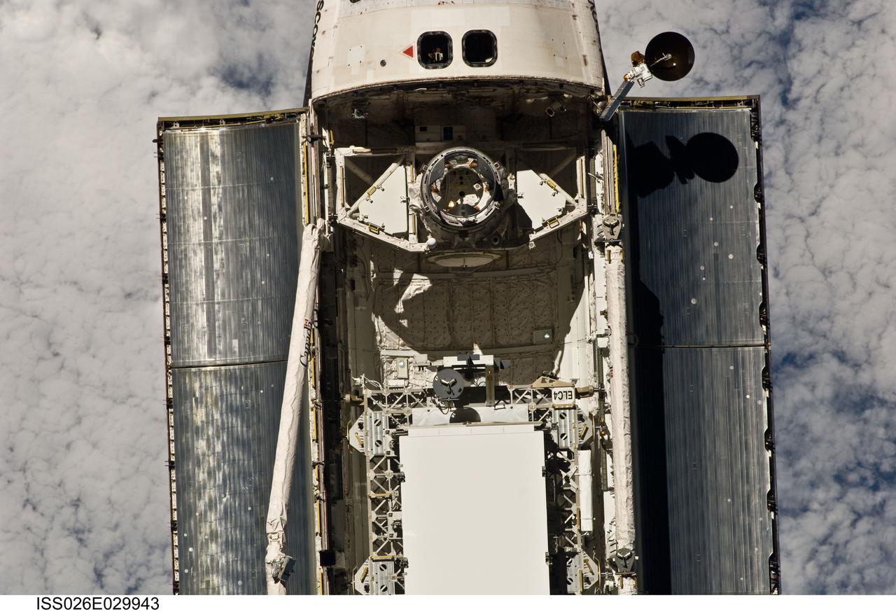 ISS026-E-029943 (26 Feb. 2011) --- This view of the crew cabin and forward payload bay of the space shuttle Discovery was provided by an Expedition 26 crew member during a survey of the approaching STS-133 vehicle prior to docking with the International Space Station. As part of the survey and part of every mission's activities, Discovery performed a back-flip for the rendezvous pitch maneuver (RPM). The image was photographed with a digital still camera, using a 400mm lens at a distance of about 600 feet (180 meters).