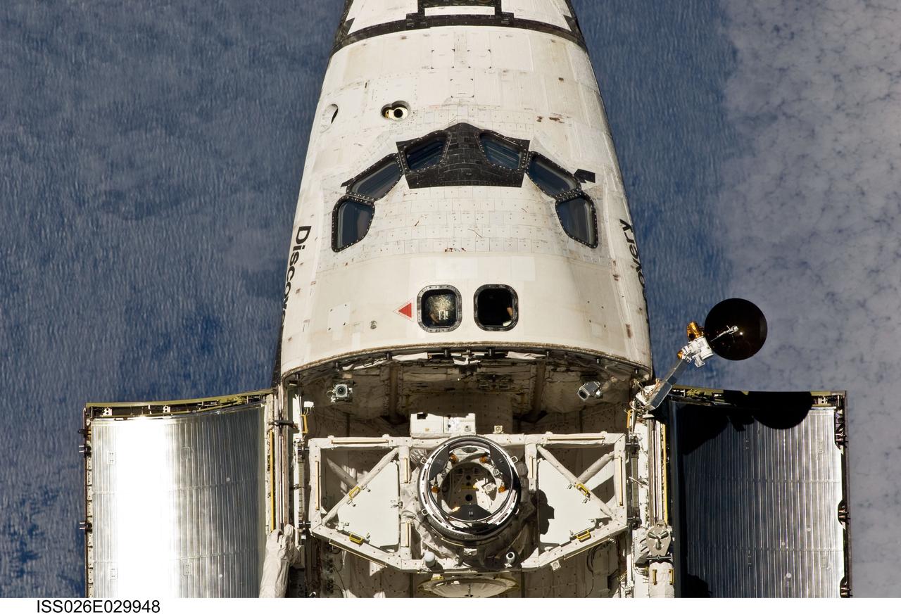 ISS026-E-029948 (26 Feb. 2011) --- This view of the crew cabin and forward payload bay of the space shuttle Discovery was provided by an Expedition 26 crew member during a survey of the approaching STS-133 vehicle prior to docking with the International Space Station. As part of the survey and part of every mission's activities, Discovery performed a back-flip for the rendezvous pitch maneuver (RPM). The image was photographed with a digital still camera, using a 400mm lens at a distance of about 600 feet (180 meters).