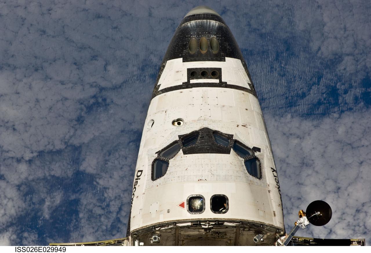 ISS026-E-029949 (26 Feb. 2011) --- This view of the crew cabin of the space shuttle Discovery was provided by an Expedition 26 crew member during a survey of the approaching STS-133 vehicle prior to docking with the International Space Station. As part of the survey and part of every mission's activities, Discovery performed a back-flip for the rendezvous pitch maneuver (RPM). The image was photographed with a digital still camera, using a 400mm lens at a distance of about 600 feet (180 meters).