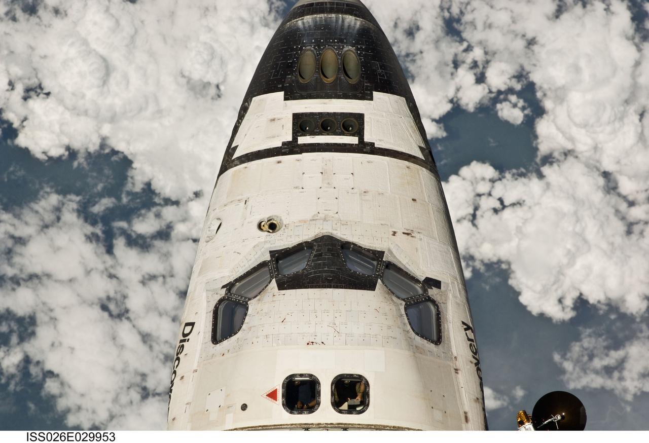 ISS026-E-029953 (26 Feb. 2011) --- This view of the crew cabin of the space shuttle Discovery was provided by an Expedition 26 crew member during a survey of the approaching STS-133 vehicle prior to docking with the International Space Station. As part of the survey and part of every mission's activities, Discovery performed a back-flip for the rendezvous pitch maneuver (RPM). The image was photographed with a digital still camera, using a 400mm lens at a distance of about 600 feet (180 meters).