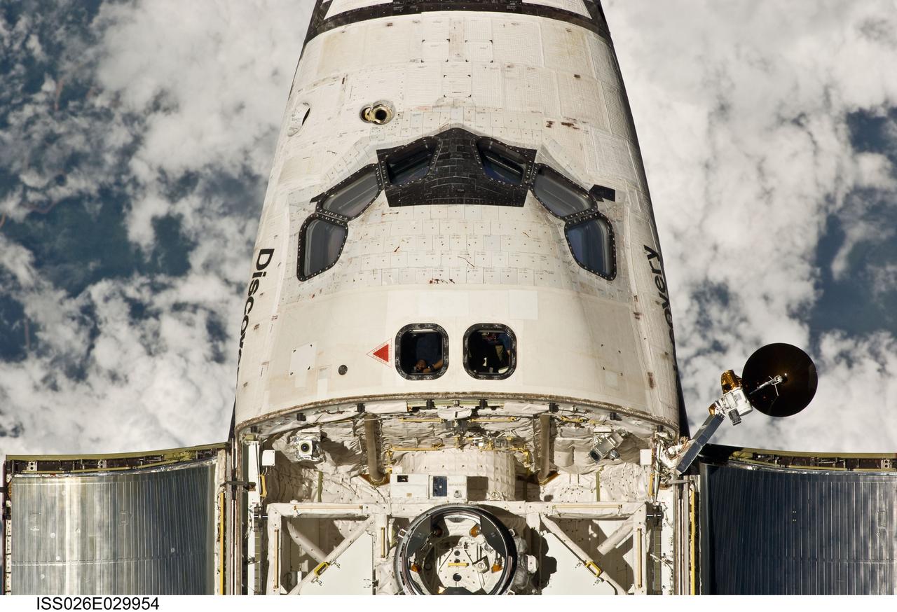 ISS026-E-029954 (26 Feb. 2011) --- This view of the crew cabin and forward payload bay of the space shuttle Discovery was provided by an Expedition 26 crew member during a survey of the approaching STS-133 vehicle prior to docking with the International Space Station. As part of the survey and part of every mission's activities, Discovery performed a back-flip for the rendezvous pitch maneuver (RPM). The image was photographed with a digital still camera, using a 400mm lens at a distance of about 600 feet (180 meters).