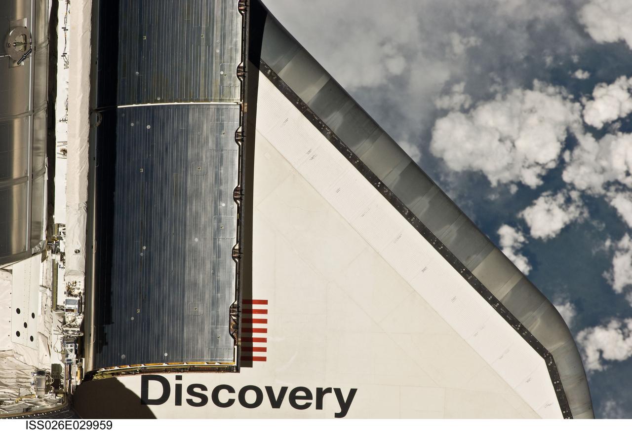 ISS026-E-029959 (26 Feb. 2011) --- This partial view of the starboard wing of the space shuttle Discovery was provided by an Expedition 26 crew member during a survey of the approaching STS-133 vehicle prior to docking with the International Space Station. As part of the survey and part of every mission's activities, Discovery performed a back-flip for the rendezvous pitch maneuver (RPM). The image was photographed with a digital still camera, using a 400mm lens at a distance of about 600 feet (180 meters).