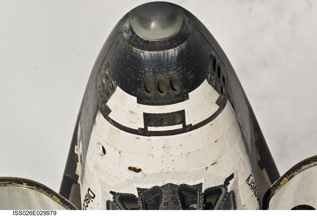 ISS026-E-029979 (26 Feb. 2011) --- This view of the nose and partial crew cabin of the space shuttle Discovery was provided by an Expedition 26 crew member during a survey of the approaching STS-133 vehicle prior to docking with the International Space Station. As part of the survey and part of every mission's activities, Discovery performed a back-flip for the rendezvous pitch maneuver (RPM). The image was photographed with a digital still camera, using a 400mm lens at a distance of about 600 feet (180 meters).