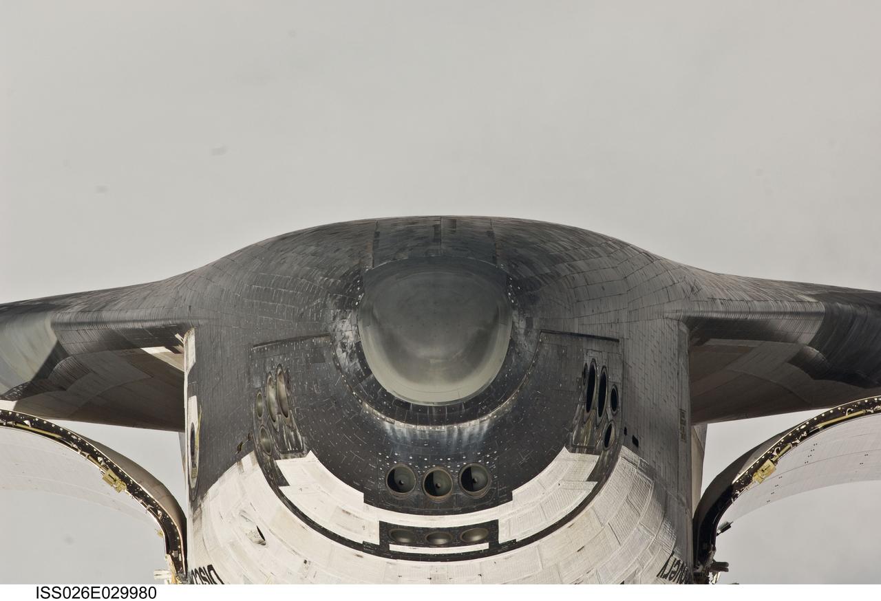 ISS026-E-029980 (26 Feb. 2011) --- This view of the nose and the forward underside of the space shuttle Discovery was provided by an Expedition 26 crew member during a survey of the approaching STS-133 vehicle prior to docking with the International Space Station. As part of the survey and part of every mission's activities, Discovery performed a back-flip for the rendezvous pitch maneuver (RPM). The image was photographed with a digital still camera, using a 400mm lens at a distance of about 600 feet (180 meters).