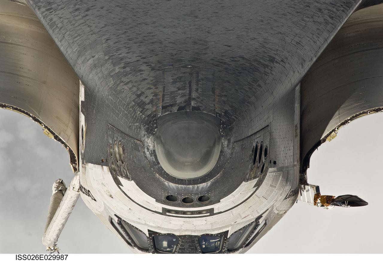 ISS026-E-029987 (26 Feb. 2011) --- This view of the nose, the forward underside and crew cabin of the space shuttle Discovery was provided by an Expedition 26 crew member during a survey of the approaching STS-133 vehicle prior to docking with the International Space Station. As part of the survey and part of every mission's activities, Discovery performed a back-flip for the rendezvous pitch maneuver (RPM). The image was photographed with a digital still camera, using a 400mm lens at a distance of about 600 feet (180 meters).