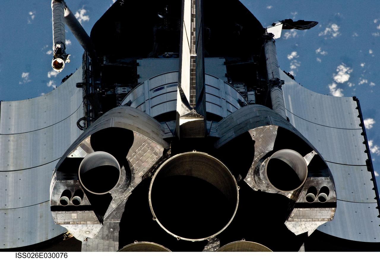 ISS026-E-030076 (26 Feb. 2011) --- This view of the aft portion of the space shuttle Discovery, including main engines, part of the cargo bay, vertical stabilizer and orbital maneuvering system (OMS) pods was provided by an Expedition 26 crew member during a survey of the approaching STS-133 vehicle prior to docking with the International Space Station. As part of the survey and part of every mission's activities, Discovery performed a back-flip for the rendezvous pitch maneuver (RPM). The image was photographed with a digital still camera, using a 400mm lens at a distance of about 600 feet (180 meters).