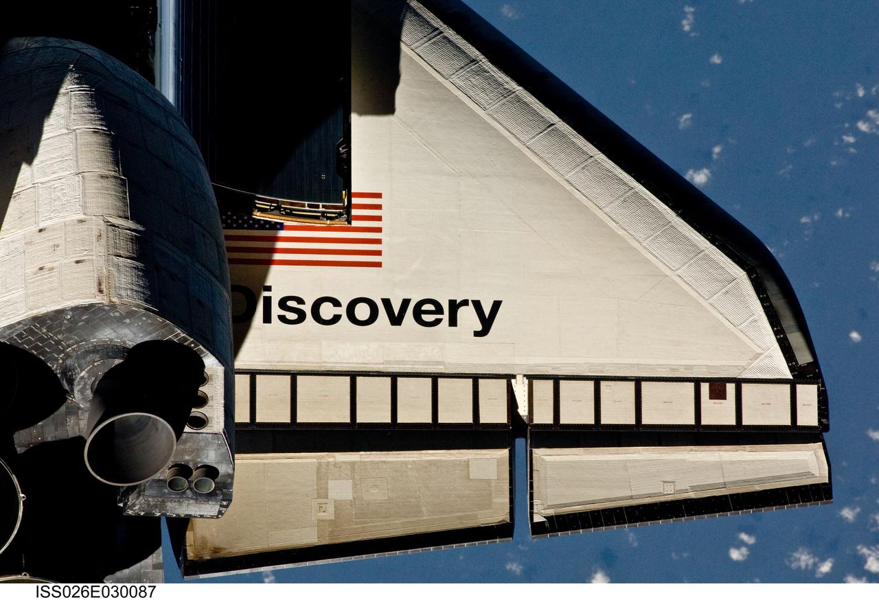 ISS026-E-030087 (26 Feb. 2011) --- This partial view of the starboard wing of the space shuttle Discovery was provided by an Expedition 26 crew member during a survey of the approaching STS-133 vehicle prior to docking with the International Space Station. As part of the survey and part of every mission's activities, Discovery performed a back-flip for the rendezvous pitch maneuver (RPM). The image was photographed with a digital still camera, using a 400mm lens at a distance of about 600 feet (180 meters).