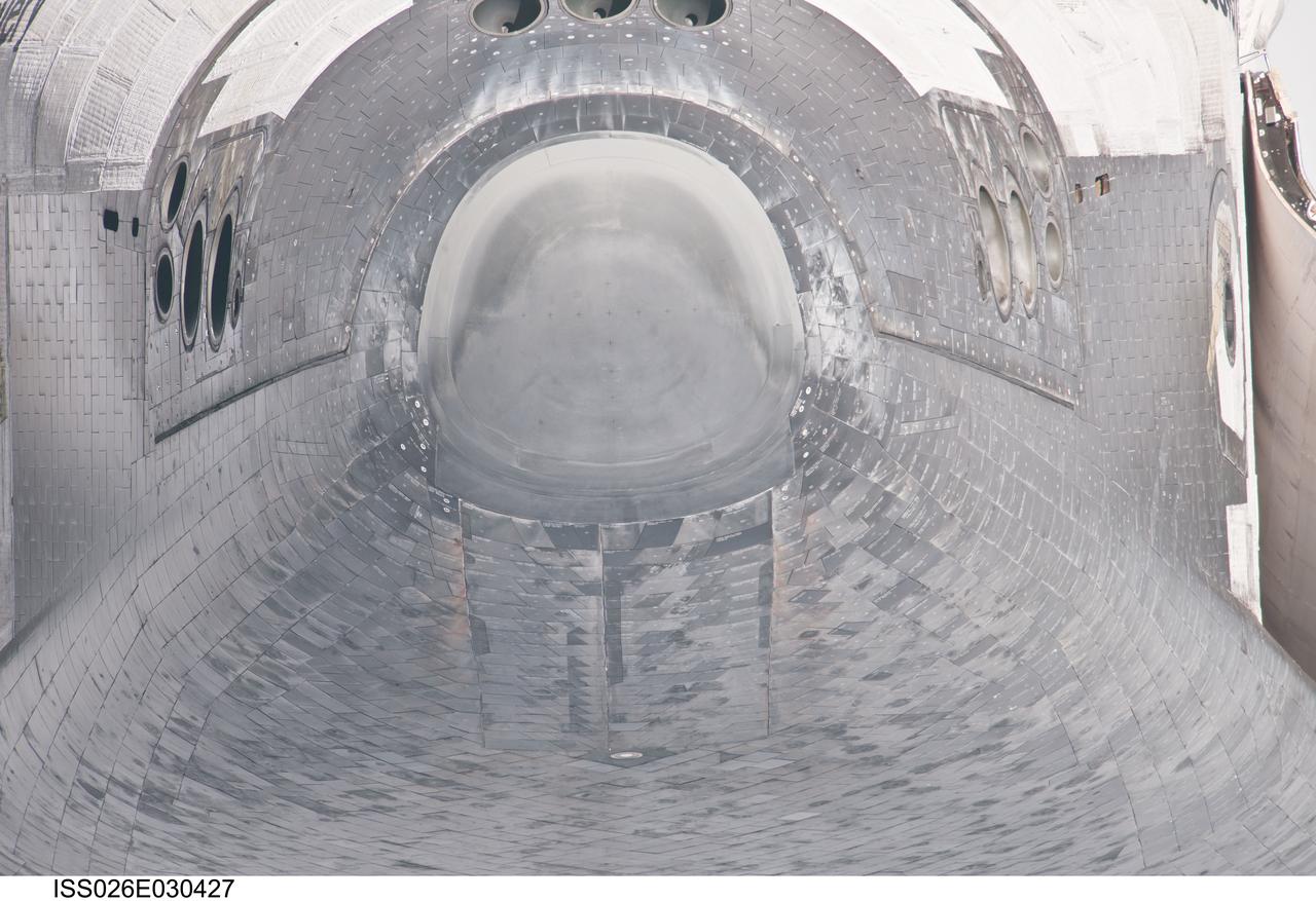 ISS026-E-030427 (26 Feb. 2011) --- This unique view of the nose and forward underside of the space shuttle Discovery was provided by an Expedition 26 crew member during a survey of the approaching STS-133 vehicle prior to docking with the International Space Station. As part of the survey and part of every mission's activities, Discovery performed a back-flip for the rendezvous pitch maneuver (RPM). The image was photographed with a digital still camera, using a 1000mm lens.