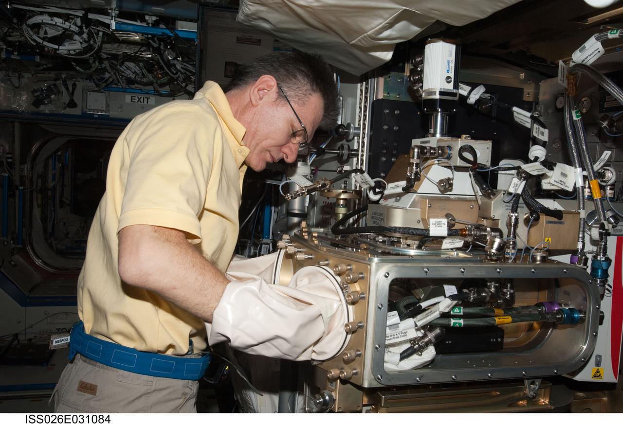 ISS026-E-031084 (1 March 2011) --- European Space Agency astronaut Paolo Nespoli, Expedition 26 flight engineer, works with the Light Microscopy Module (LMM) Spindle Bracket Assembly in the Fluids Integrated Rack (FIR) in the Destiny laboratory of the International Space Station.