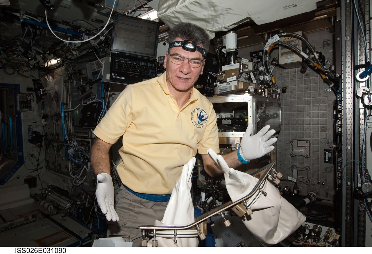 ISS026-E-031090 (1 March 2011) --- European Space Agency astronaut Paolo Nespoli, Expedition 26 flight engineer, works with the Light Microscopy Module (LMM) Spindle Bracket Assembly in the Fluids Integrated Rack (FIR) in the Destiny laboratory of the International Space Station.